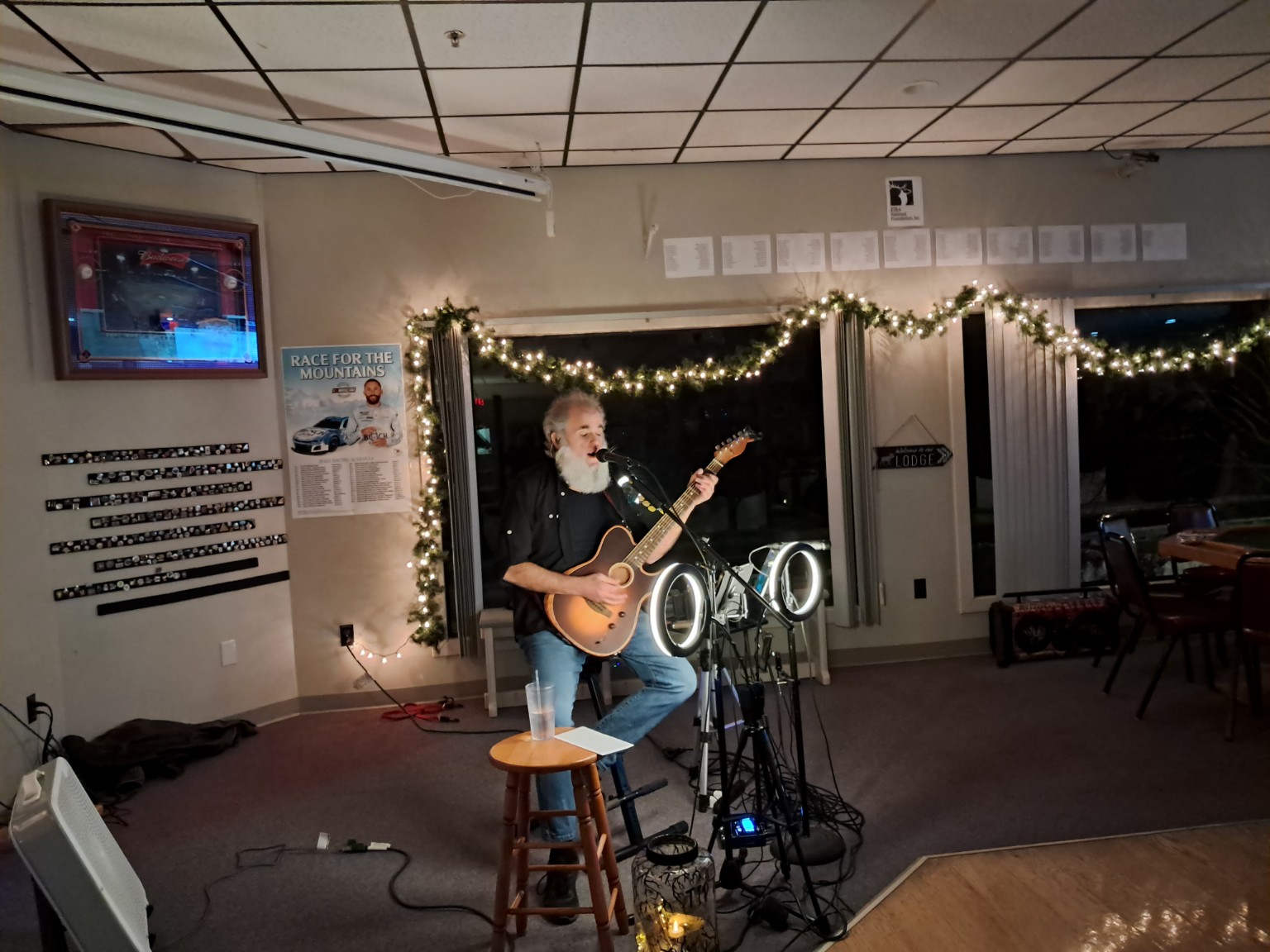 Trevor Knowles performing at a decorated venue